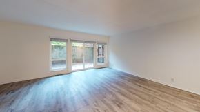 Berkeley apartment for rent - A room with a sliding glass door and wooden flooring.