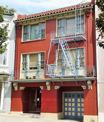 San Francisco apartment for rent - a red building with a fire escape on the side of it