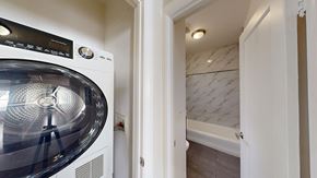 San Francisco apartment for rent - A washing machine is in a small room with a door open.