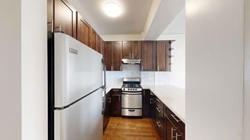 San Francisco apartment for rent - A kitchen with a refrigerator on the left and a stove top oven on the right.