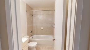 San Francisco apartment for rent - A white bathroom with a toilet, tub, and shower.