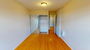 San Francisco apartment for rent - A long hallway with a wooden floor and white walls.