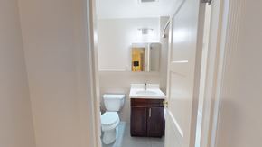 San Francisco apartment for rent - A bathroom with a toilet, sink, and mirror.