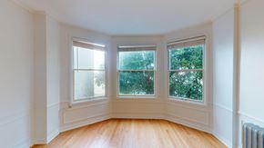 San Francisco apartment for rent - A room with a wooden floor and three windows.