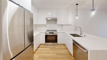 San Francisco apartment for rent - A modern kitchen with a stainless steel refrigerator and wooden flooring.