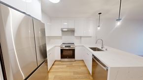 San Francisco apartment for rent - A modern kitchen with a stainless steel refrigerator and wooden flooring.