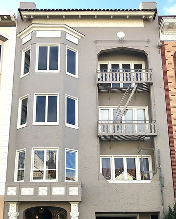 San Francisco apartment for rent - an apartment building with two balconies and a fire escape