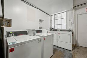 San Francisco apartment for rent - Laundry room with washing machines neatly arranged on a wooden floor