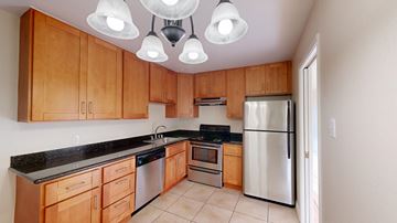 San Francisco apartment for rent - A kitchen with wooden cabinets and a stainless steel refrigerator.