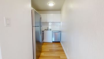 San Francisco apartment for rent - A kitchen with a refrigerator and a sink.