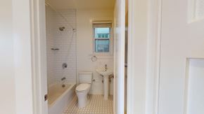 San Francisco apartment for rent - A white bathroom with a toilet, sink, and bathtub.
