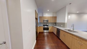 San Francisco apartment for rent - A kitchen with wooden floors and white walls.