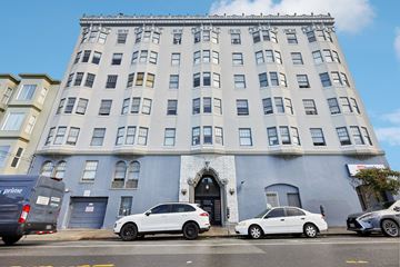 San Francisco apartment for rent - A white car is parked in front of a blue building.