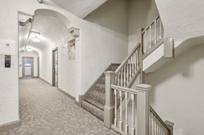 San Francisco apartment for rent - Hallway with a carpet, set of stairs with a railing and banister