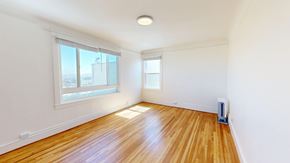 San Francisco apartment for rent - A room with wooden floors and two windows.