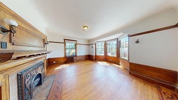 Berkeley apartment for rent - A large room with wood floors and a fireplace.