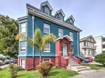 Berkeley apartment for rent - A blue house with a red door and steps leading up to it.