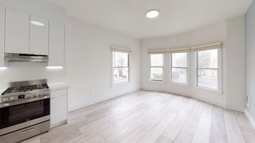 San Francisco apartment for rent - A kitchen with a stove top oven and a window.