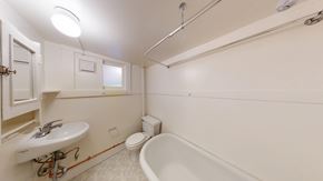 Berkeley apartment for rent - A white bathroom with a tub, toilet, and sink.