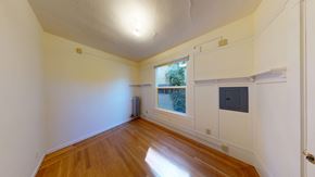 Berkeley apartment for rent - A room with wooden floors and white walls.