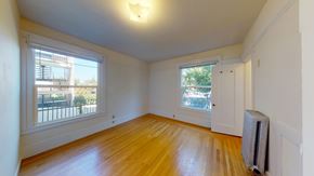 Berkeley apartment for rent - A room with wooden floors and a window overlooking a balcony.