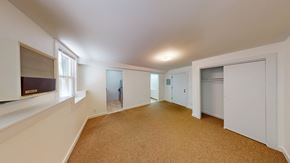 Berkeley apartment for rent - A spacious room with white walls and carpeted floor.
