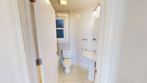 San Francisco apartment for rent - A bathroom with a toilet, sink, and window.