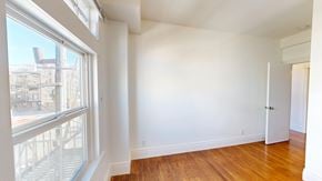San Francisco apartment for rent - A room with a window overlooking a cityscape.