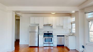 San Francisco apartment for rent - A kitchen with white cabinets and stainless steel appliances.