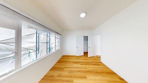Berkeley apartment for rent - A long empty room with wooden floors and white walls.