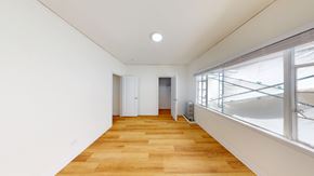 Berkeley apartment for rent - A long hallway with wooden floors and white walls.