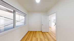 Berkeley apartment for rent - A room with a white door and a window with a view of a parking lot.