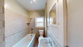 Berkeley apartment for rent - A white bathroom with a tub, toilet and sink.