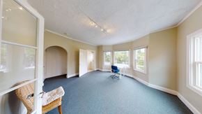 Berkeley apartment for rent - A room with a blue carpet and a chair.
