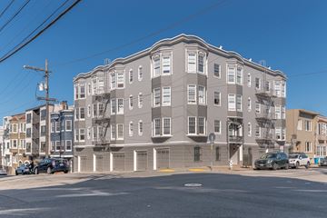 San Francisco apartment for rent - A large grey building with a flat roof and a yellow line in front of it.