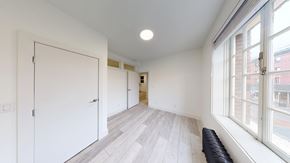 Berkeley apartment for rent - A room with a white door, a window, and a bench.