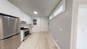 Berkeley apartment for rent - A modern kitchen with stainless steel appliances and wooden flooring.