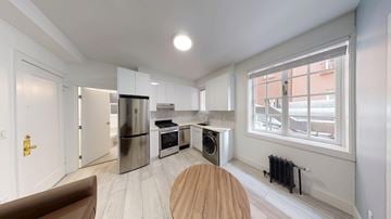 Berkeley apartment for rent - A modern kitchen with a wooden table and chairs.