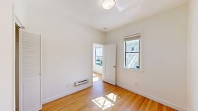 San Francisco apartment for rent - A room with a wooden floor and a window with blinds.