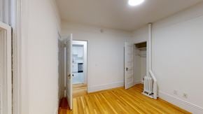 Berkeley apartment for rent - A room with wooden floors and white walls.