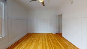 Berkeley apartment for rent - A room with wooden floors and white walls.