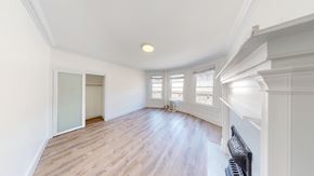 Berkeley apartment for rent - A room with wooden floors and white walls.