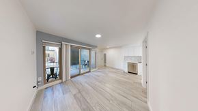 Berkeley apartment for rent - A spacious room with a fireplace and a large window.