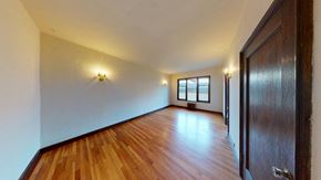 Berkeley apartment for rent - A room with wooden floors and a door on the right.