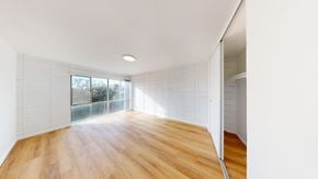 Berkeley apartment for rent - A room with wooden floors and white walls.