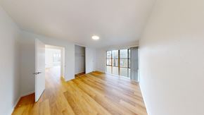 Berkeley apartment for rent - A room with wooden floors and white walls.