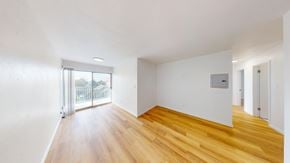 Berkeley apartment for rent - A room with wooden floors and white walls.