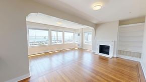 San Francisco apartment for rent - A spacious living room with a fireplace and large windows.