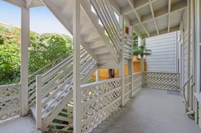 San Francisco apartment for rent - A white staircase with a metal railing leads to a door.