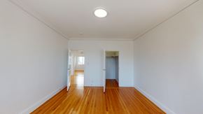 San Francisco apartment for rent - A room with wooden floors and white walls.